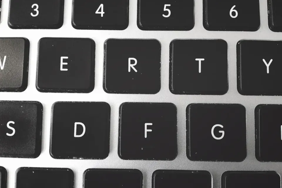 Close-up of black keys on a silver laptop keyboard