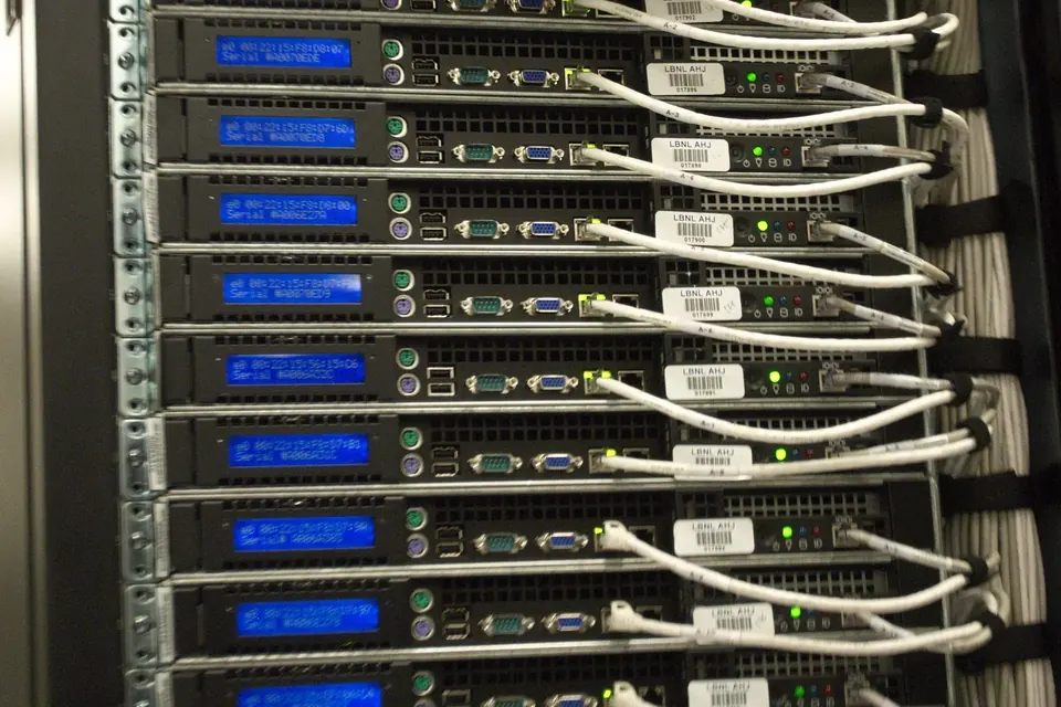 Rear of a server rack with rows of rack servers and neatly bundled network cables